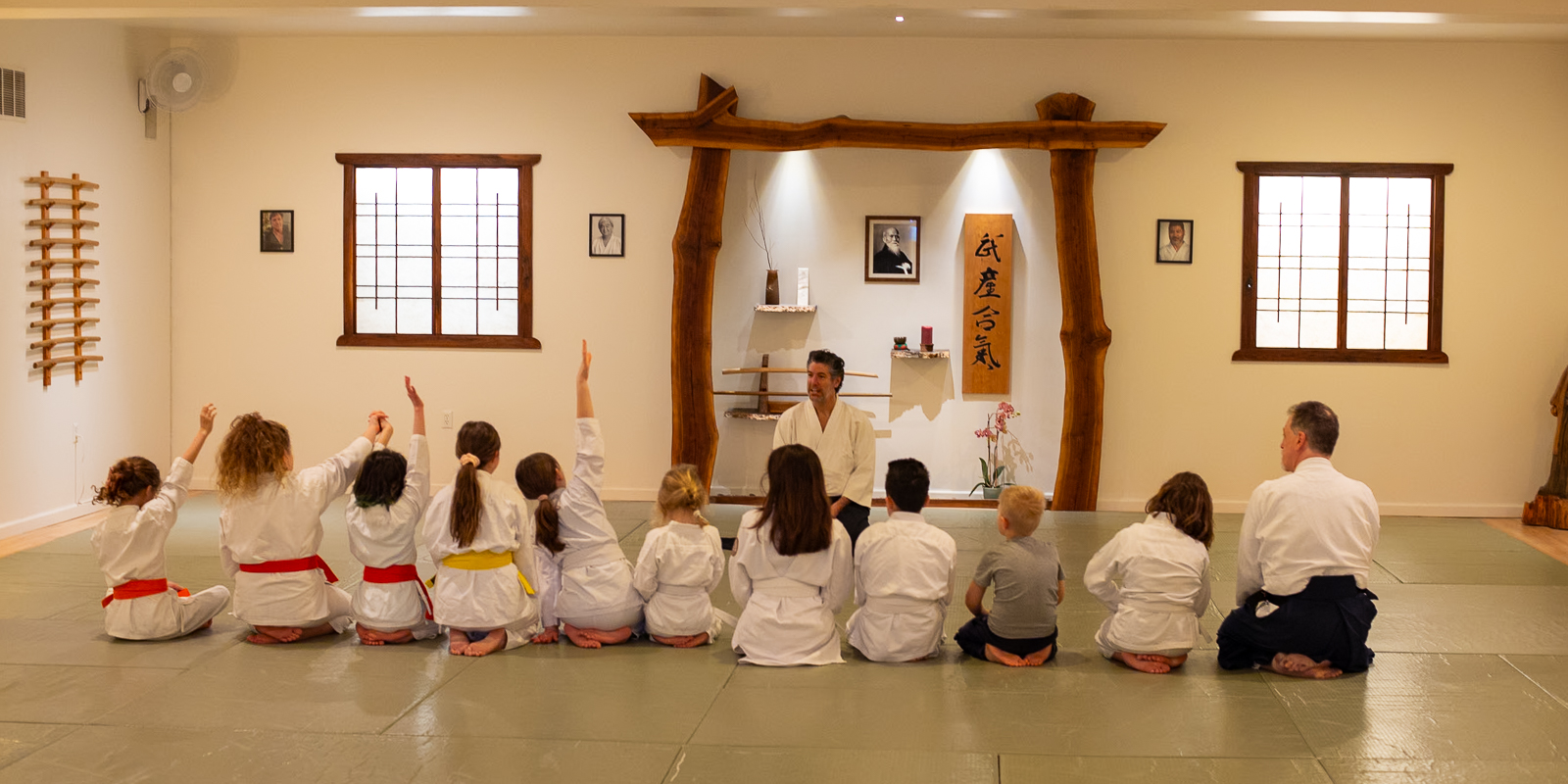 Children lined up and raising hands