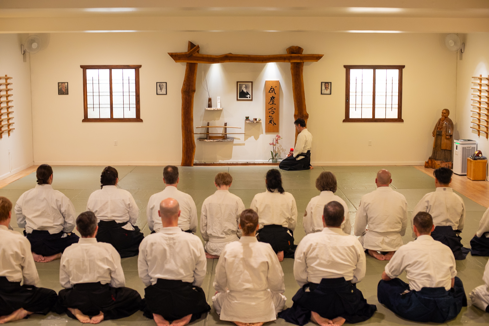 Students lined up at the start of class with sensei lighting a candle